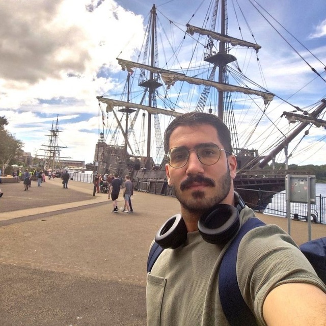 Mahdi Mohseni near historic sailing ships